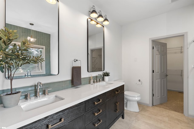 bathroom featuring tile patterned flooring, vanity, and toilet