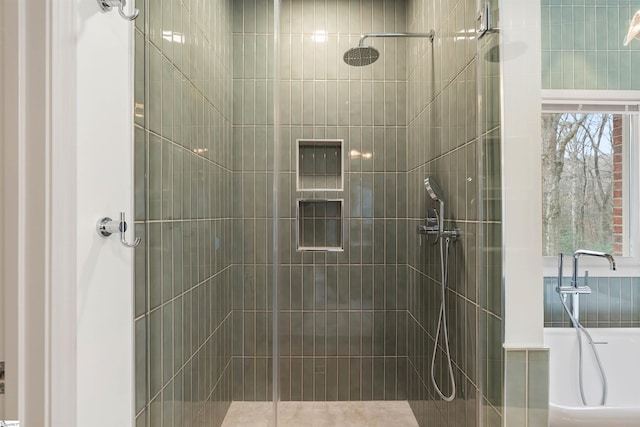 bathroom featuring a shower with door