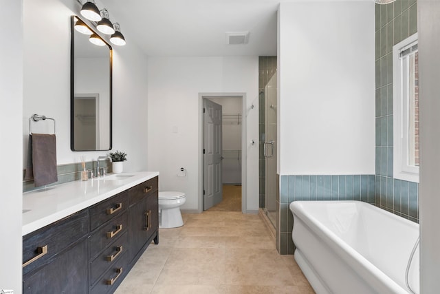 full bathroom with vanity, tile patterned floors, shower with separate bathtub, and toilet