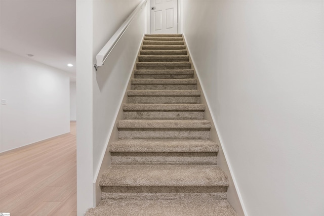 staircase with wood-type flooring