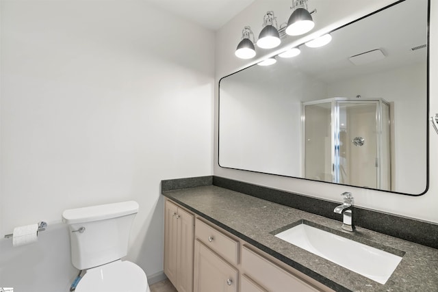 bathroom with walk in shower, vanity, and toilet