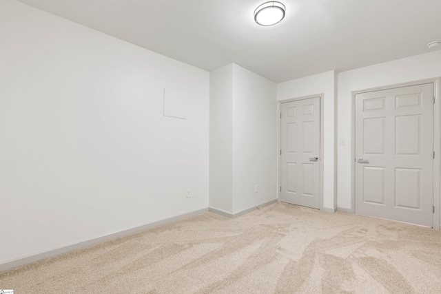 unfurnished bedroom featuring light carpet