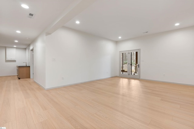 unfurnished room featuring sink and light hardwood / wood-style flooring