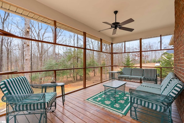 sunroom / solarium featuring ceiling fan