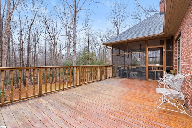 wooden deck featuring a sunroom and ceiling fan