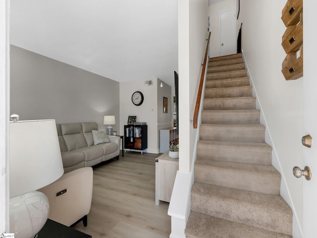 stairs with hardwood / wood-style flooring