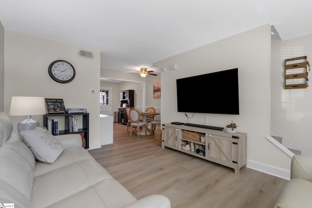 living room featuring ceiling fan and light wood-type flooring