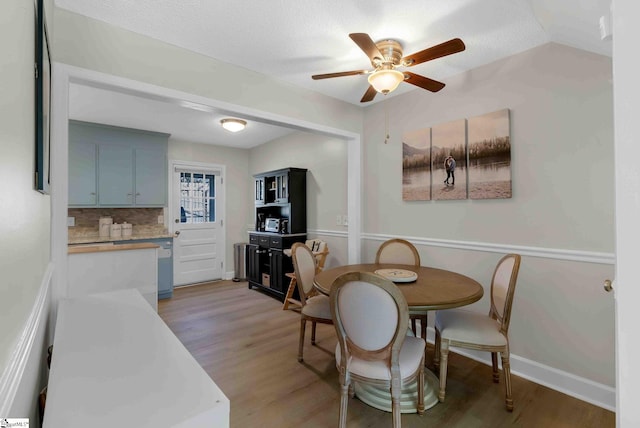 dining area featuring wood-type flooring and ceiling fan