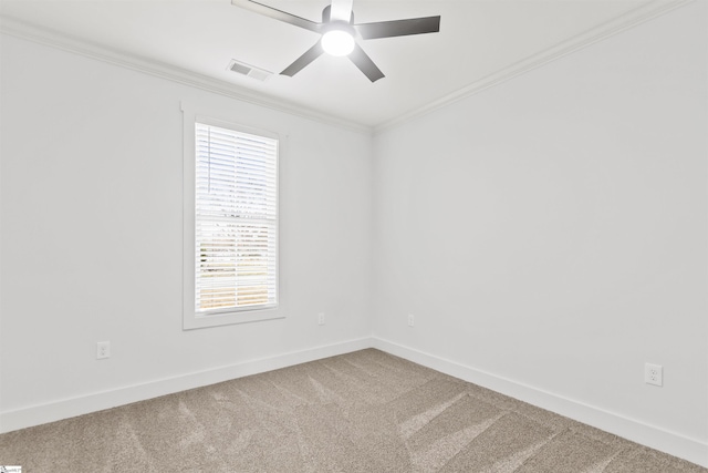 carpeted spare room featuring crown molding and ceiling fan