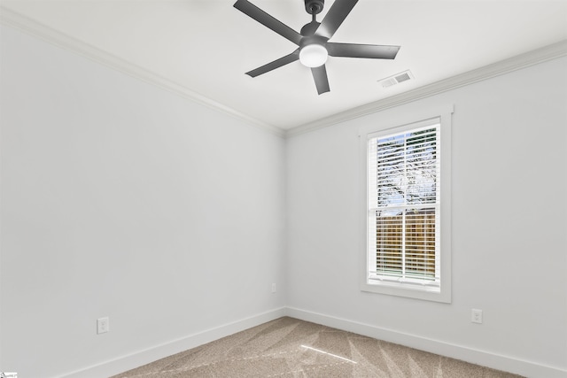 carpeted spare room featuring ornamental molding and ceiling fan