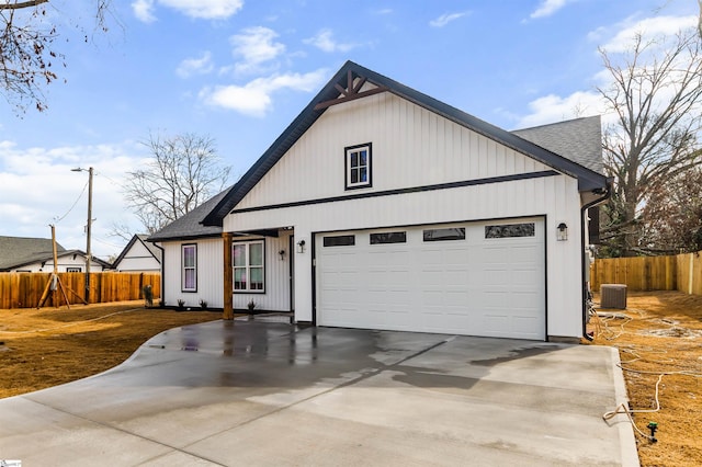 modern farmhouse featuring a garage and central AC unit