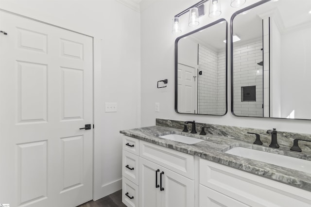 bathroom featuring vanity, hardwood / wood-style flooring, ornamental molding, and walk in shower