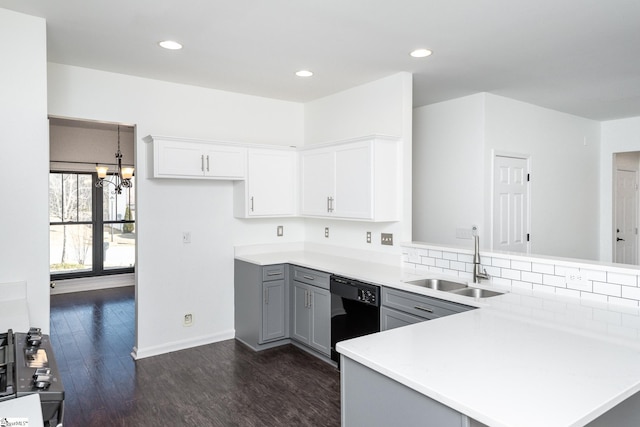 kitchen with sink, decorative light fixtures, black dishwasher, gray cabinets, and kitchen peninsula