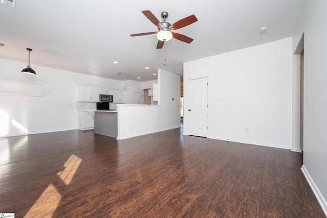 unfurnished living room with ceiling fan and dark hardwood / wood-style floors