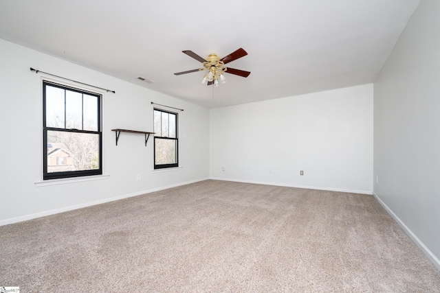 unfurnished room with ceiling fan and carpet flooring