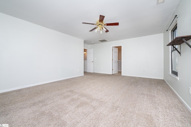 spare room with ceiling fan and light carpet