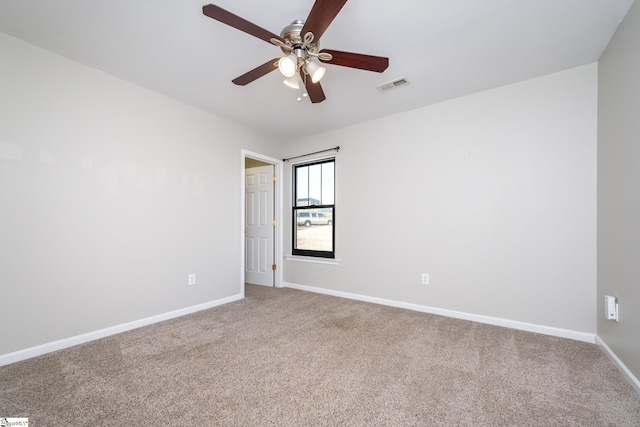 empty room featuring ceiling fan and carpet floors