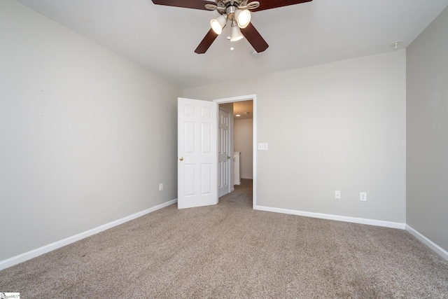 carpeted empty room featuring ceiling fan