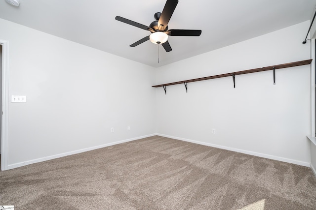 carpeted spare room featuring ceiling fan