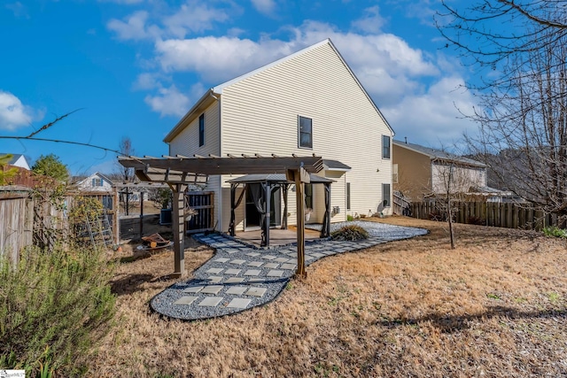 back of property featuring a patio and a pergola