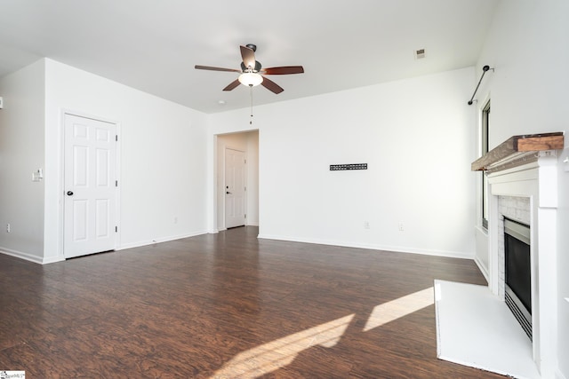 unfurnished living room with dark wood-type flooring and ceiling fan