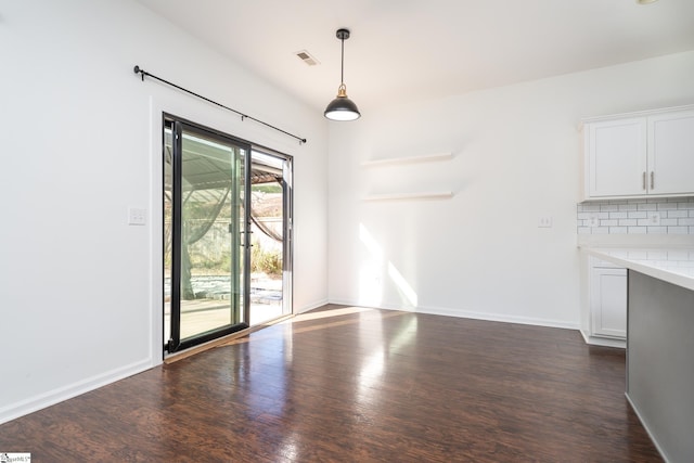 unfurnished dining area featuring dark hardwood / wood-style floors