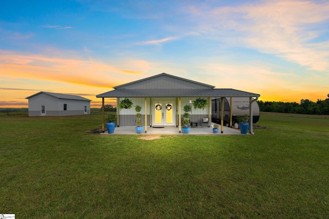 back house at dusk with a yard