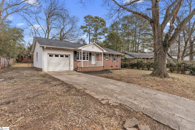 ranch-style home with a garage and covered porch