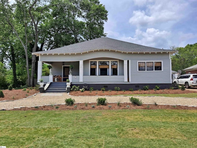 view of front facade with a front yard and a porch