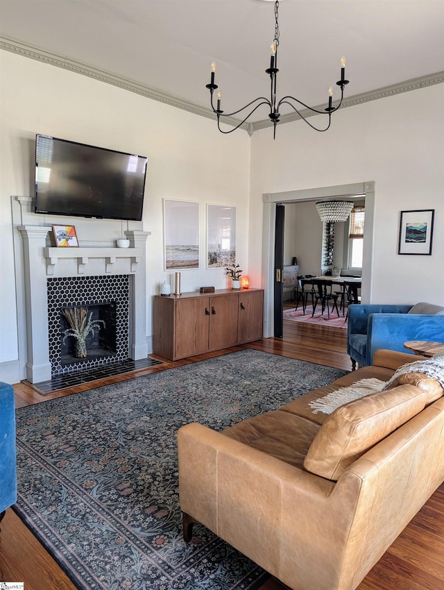 living room with hardwood / wood-style floors, a fireplace, and a chandelier