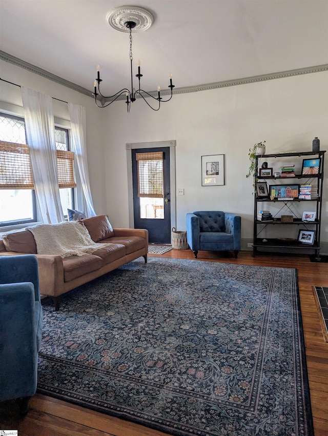 living room with dark wood-type flooring and an inviting chandelier