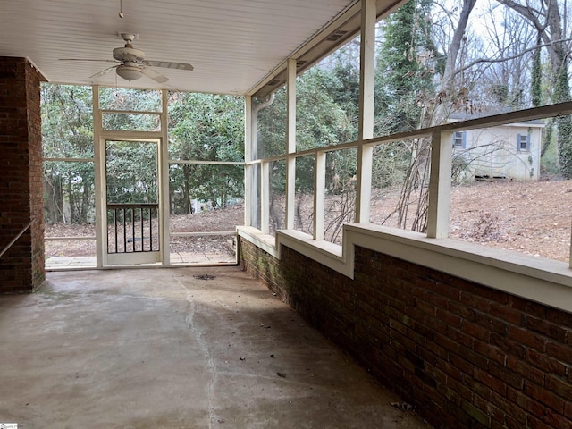 unfurnished sunroom featuring ceiling fan