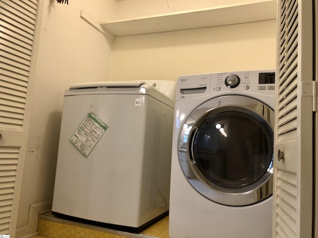 clothes washing area featuring washer and dryer