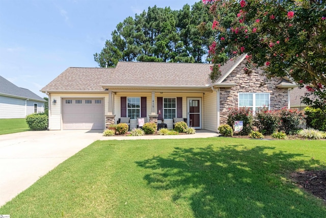 view of front of property with a garage, a front yard, and covered porch