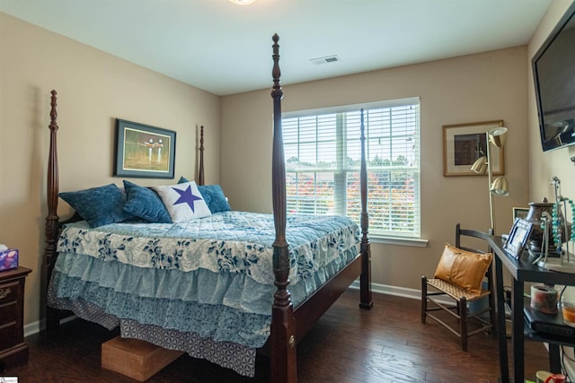 bedroom with dark hardwood / wood-style flooring