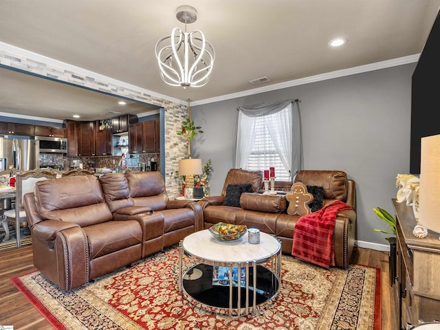 living room featuring crown molding, wood-type flooring, and a chandelier