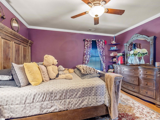 bedroom featuring crown molding, light hardwood / wood-style flooring, and ceiling fan