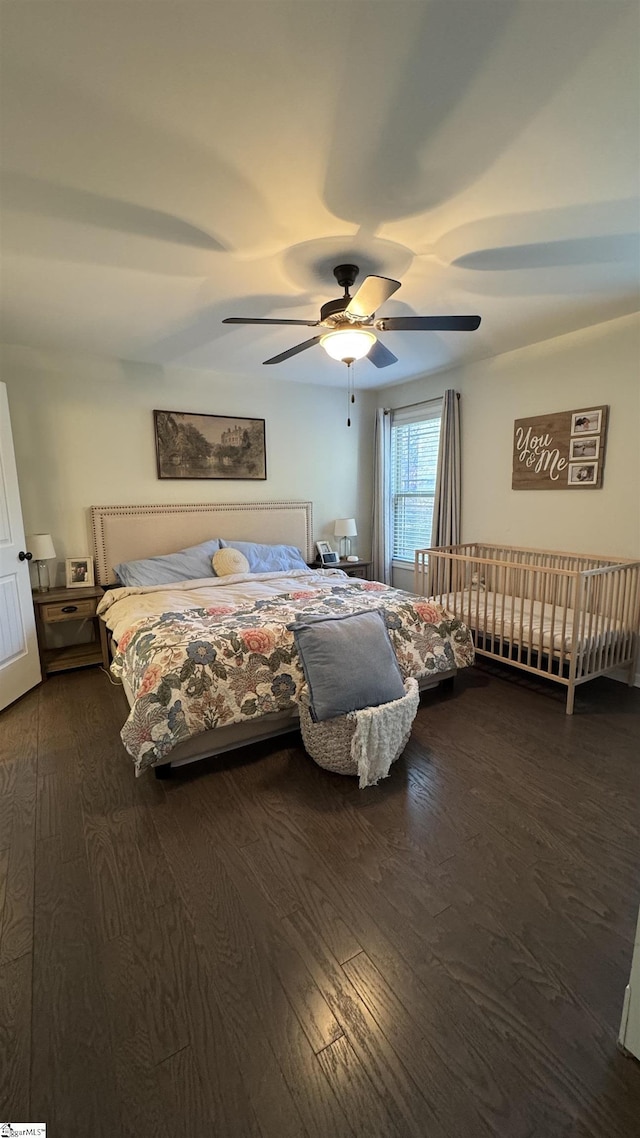 bedroom with ceiling fan and dark hardwood / wood-style floors