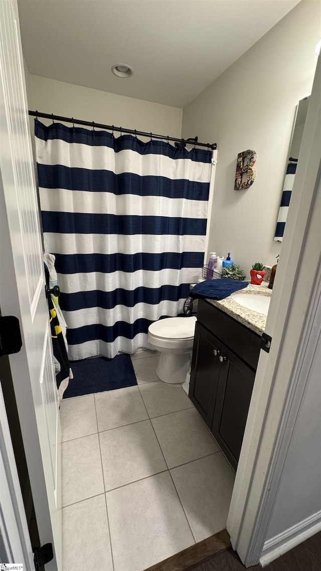 bathroom with vanity, tile patterned floors, and toilet