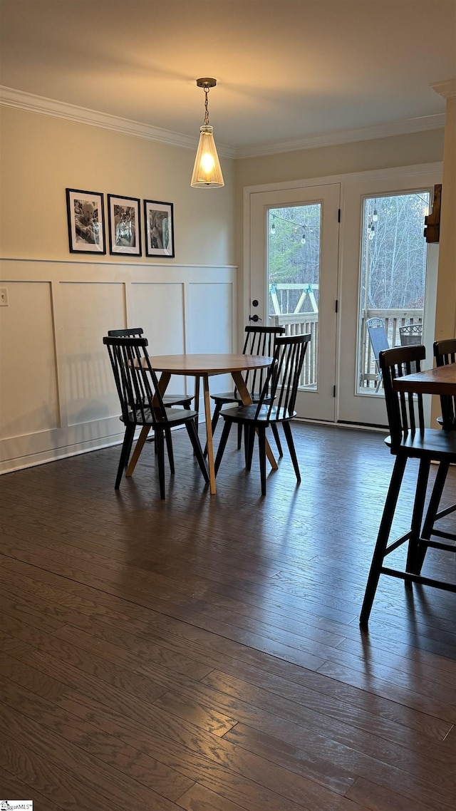 dining space featuring crown molding and dark hardwood / wood-style floors