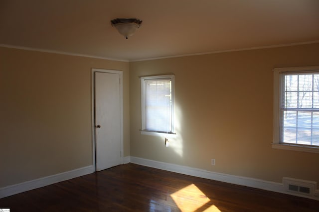 unfurnished room featuring dark hardwood / wood-style flooring and crown molding