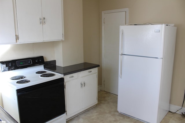 kitchen featuring range with electric cooktop, white cabinets, and white refrigerator