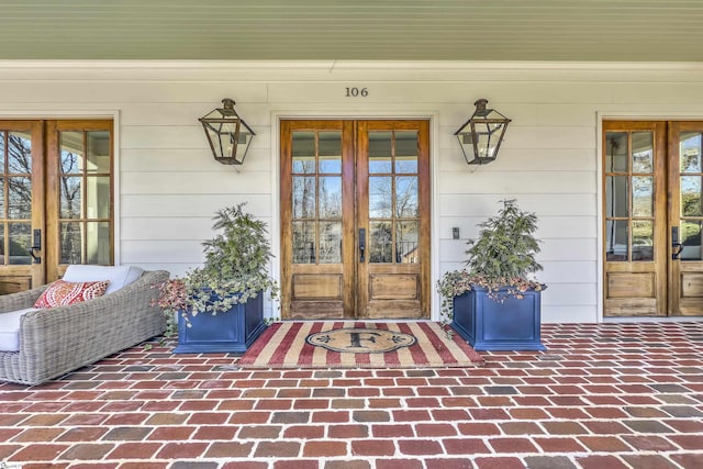 property entrance featuring french doors and covered porch