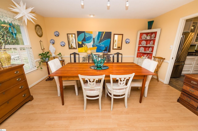 dining space featuring light wood-type flooring