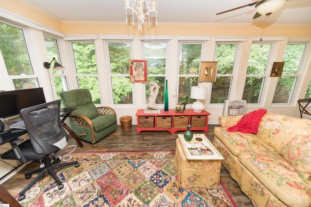 sunroom featuring ceiling fan with notable chandelier