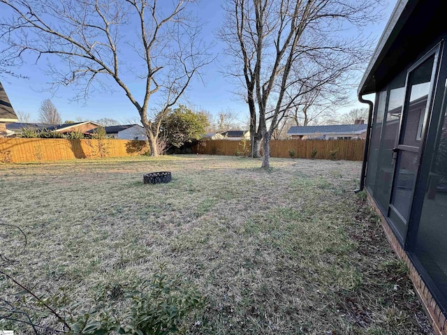 view of yard with a fire pit