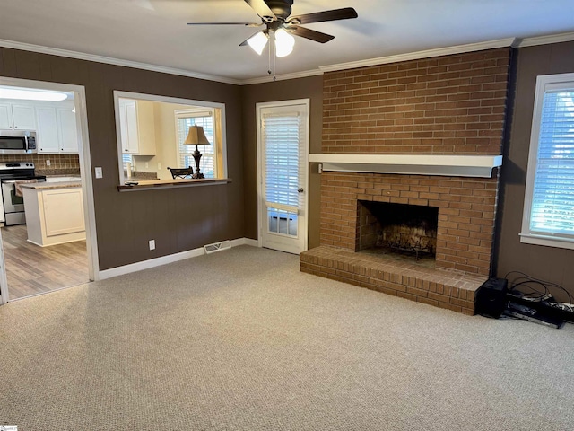 living room featuring crown molding, a brick fireplace, and light carpet