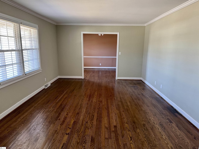 spare room featuring dark wood-type flooring and crown molding