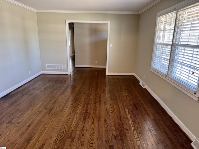 empty room featuring crown molding and dark hardwood / wood-style flooring