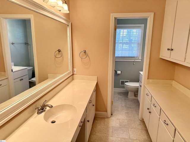 bathroom with vanity, toilet, and tile patterned flooring